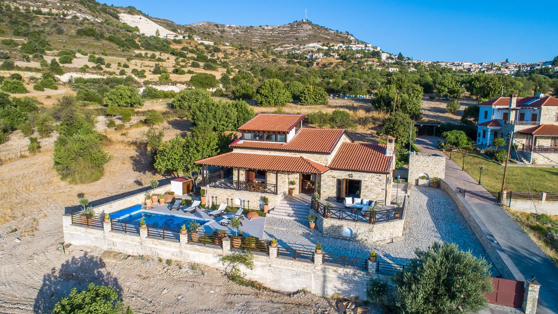 The villa and pool with the hills behind