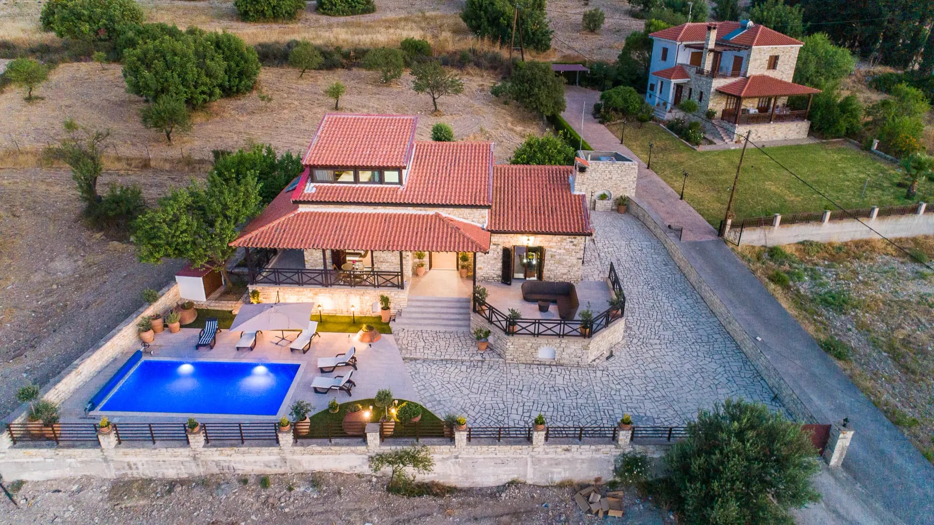 Lefkara Villa with its pool lit at dusk