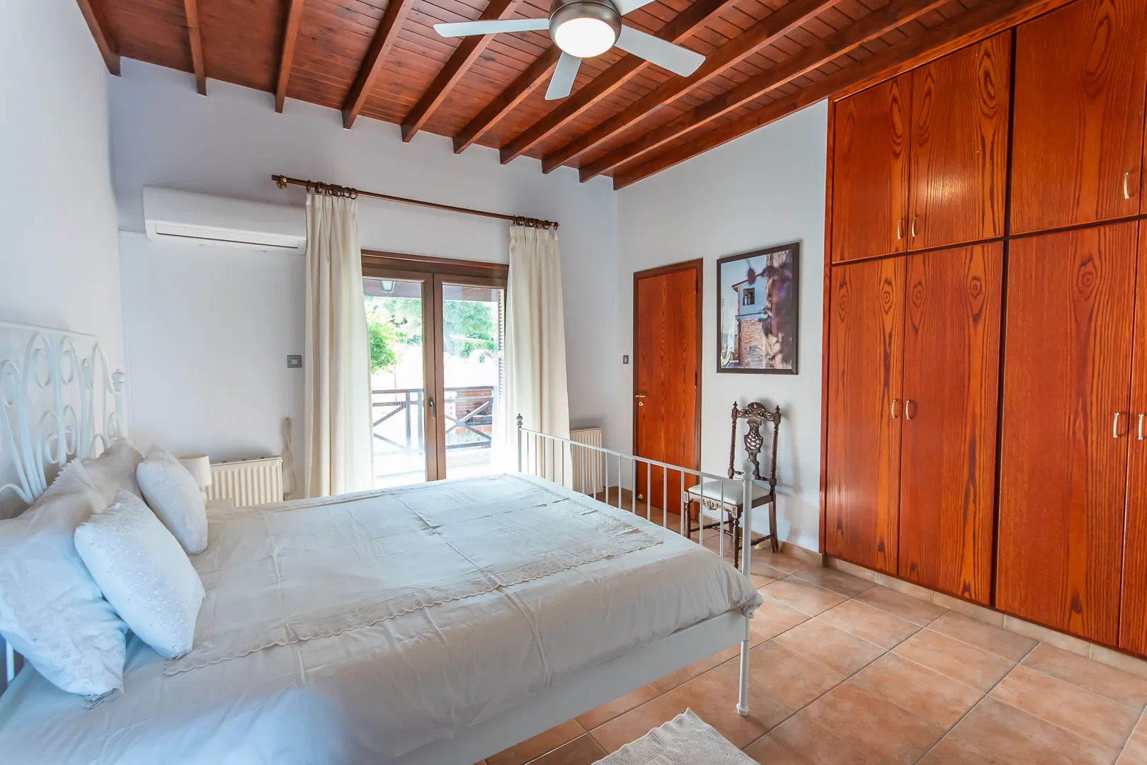 Bedroom with wooden ceiling and wardrobe