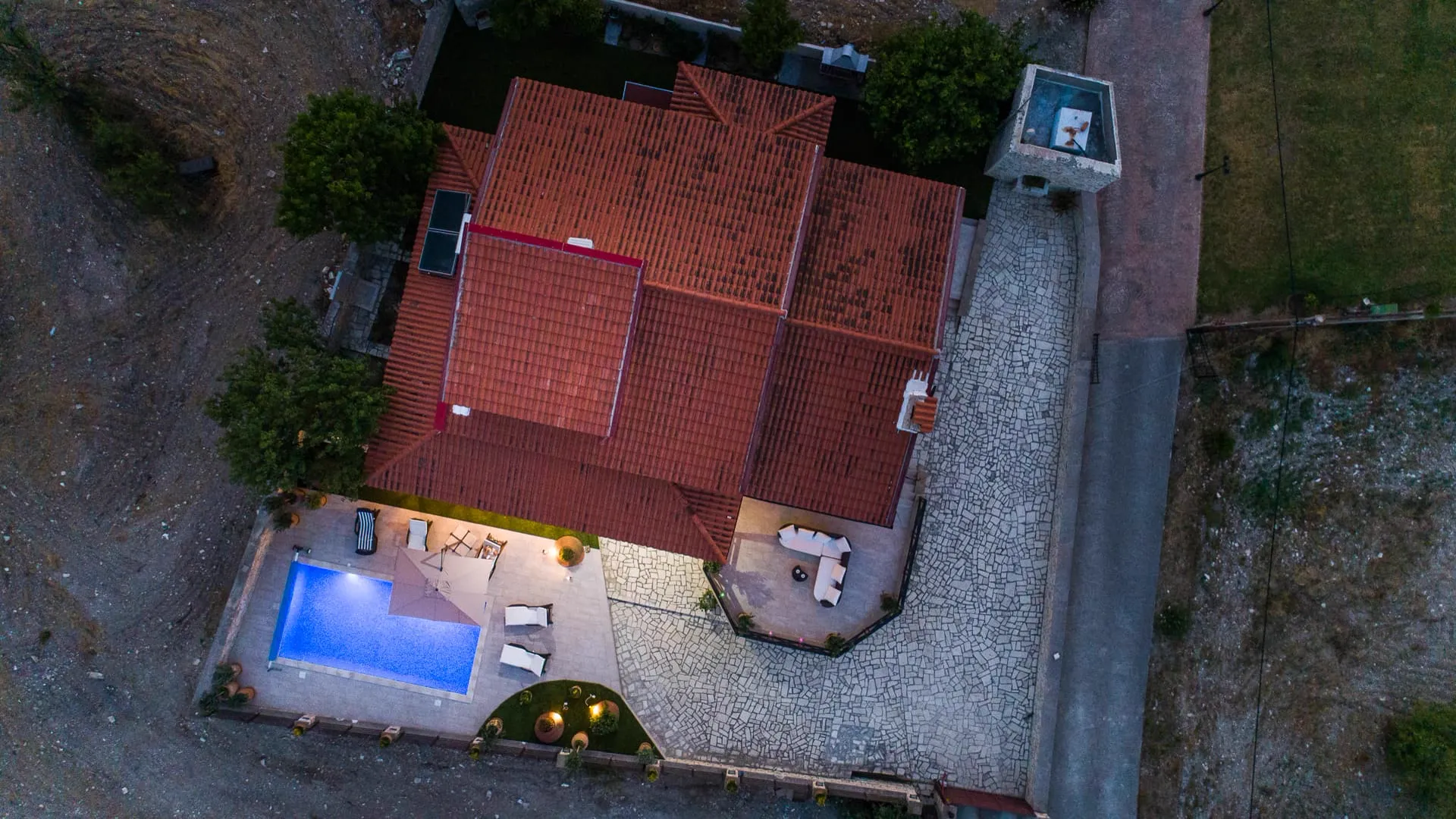 Terracotta roof and pool at dusk
