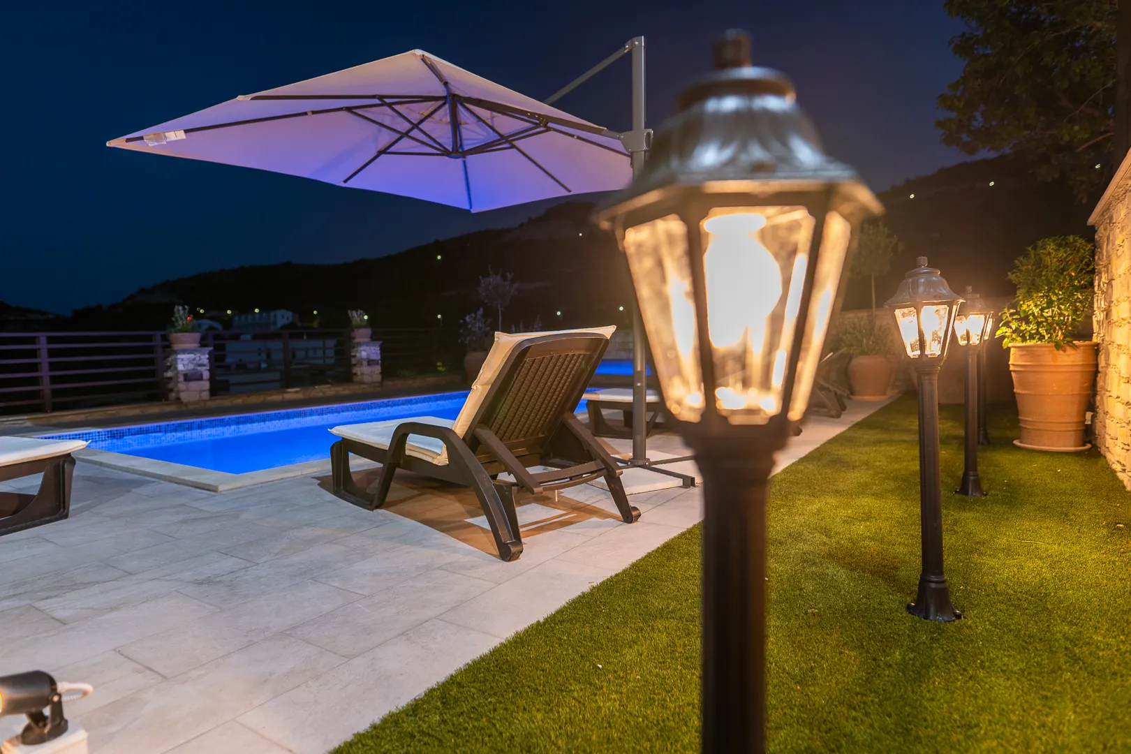 Pool and garden lanterns at night