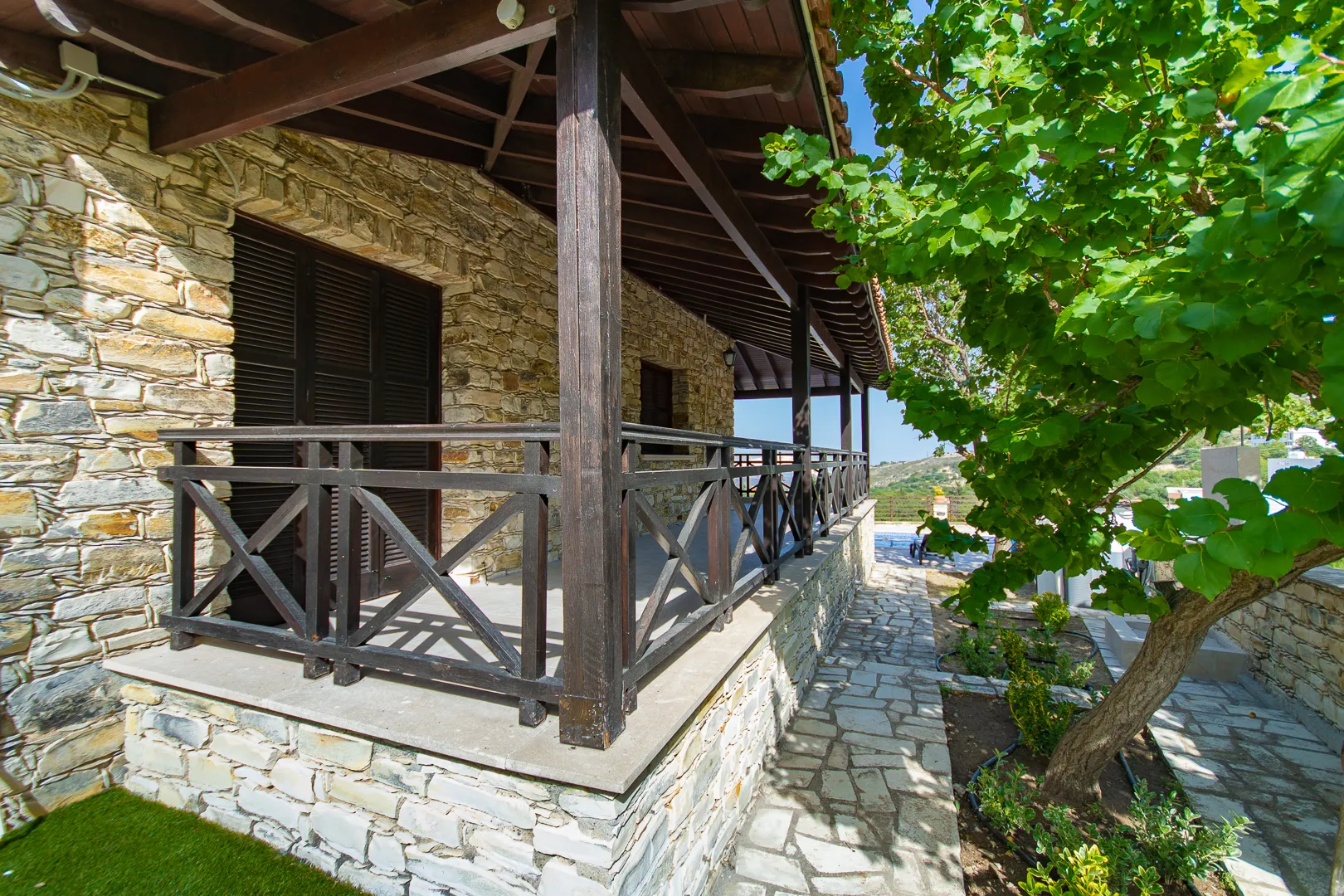 Covered veranda along the stone wall