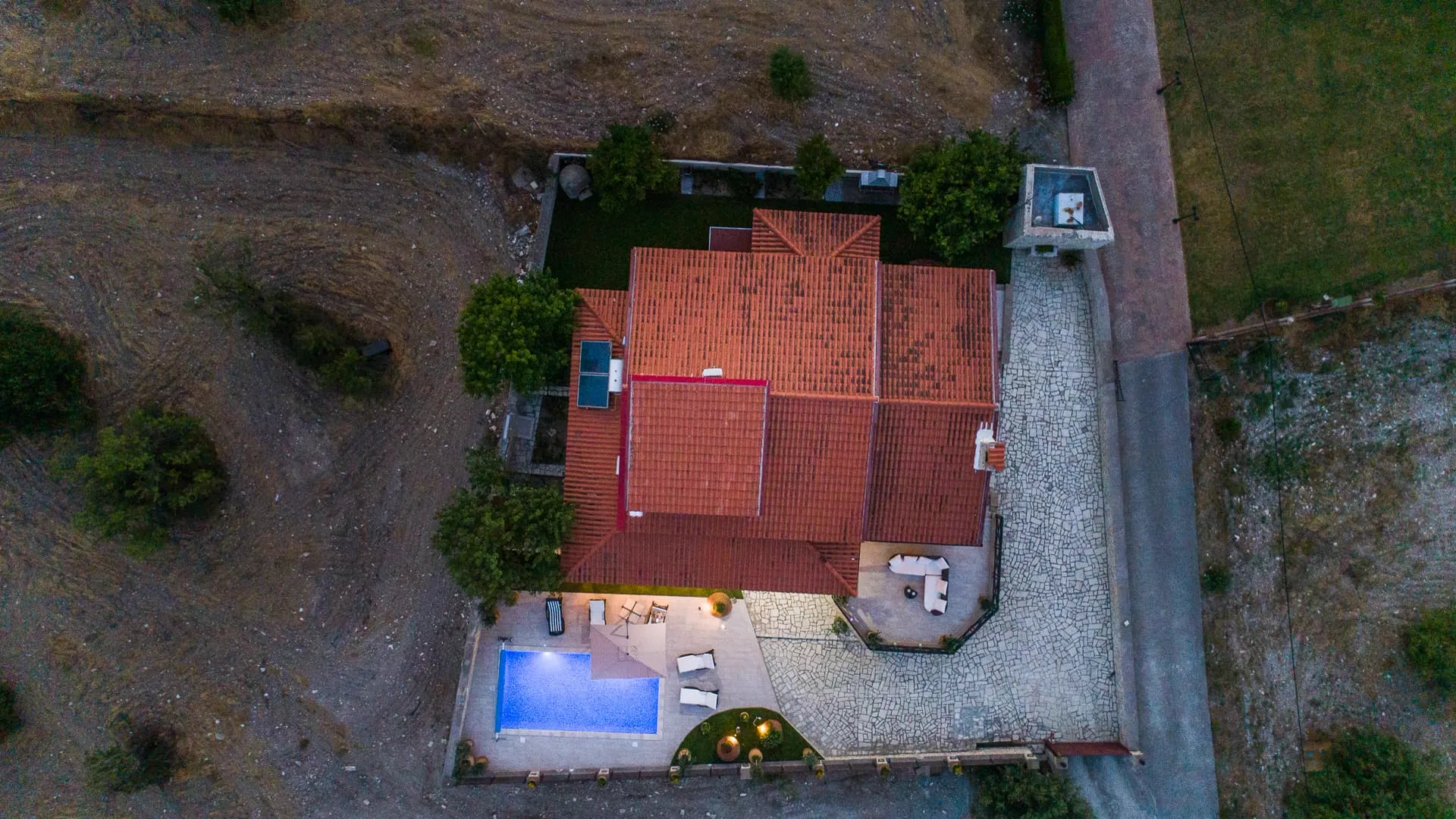 The lit pool from above in the evening