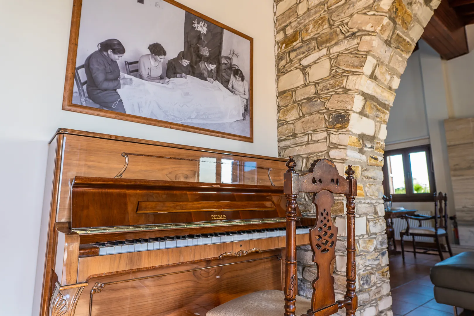 Piano under an old photo of Lefkara lace makers