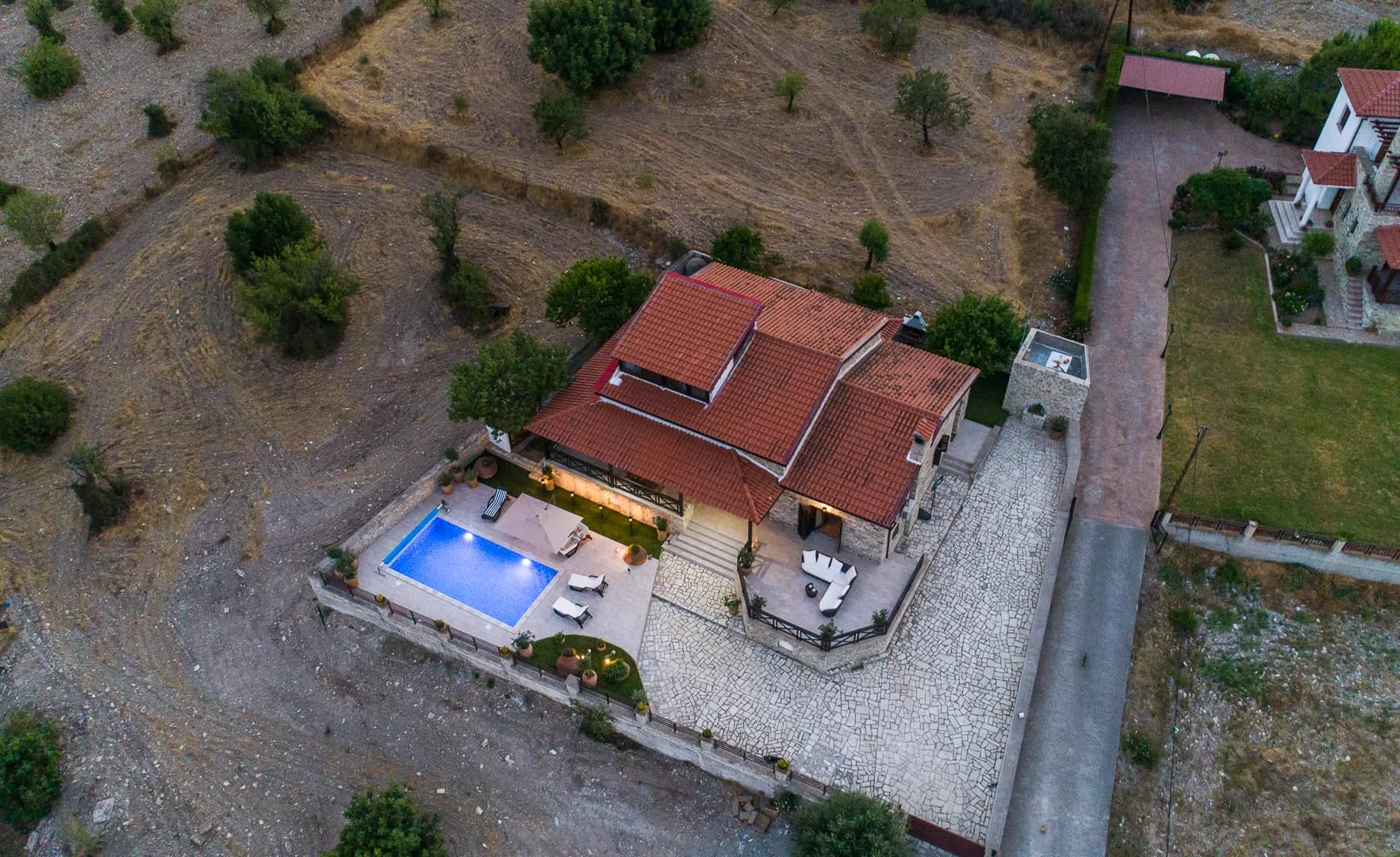 The lit pool and terrace from above