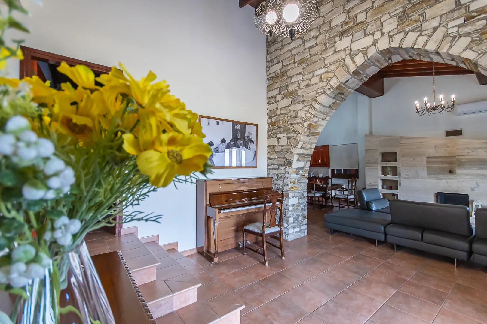 Stone arch, piano and open-plan living area